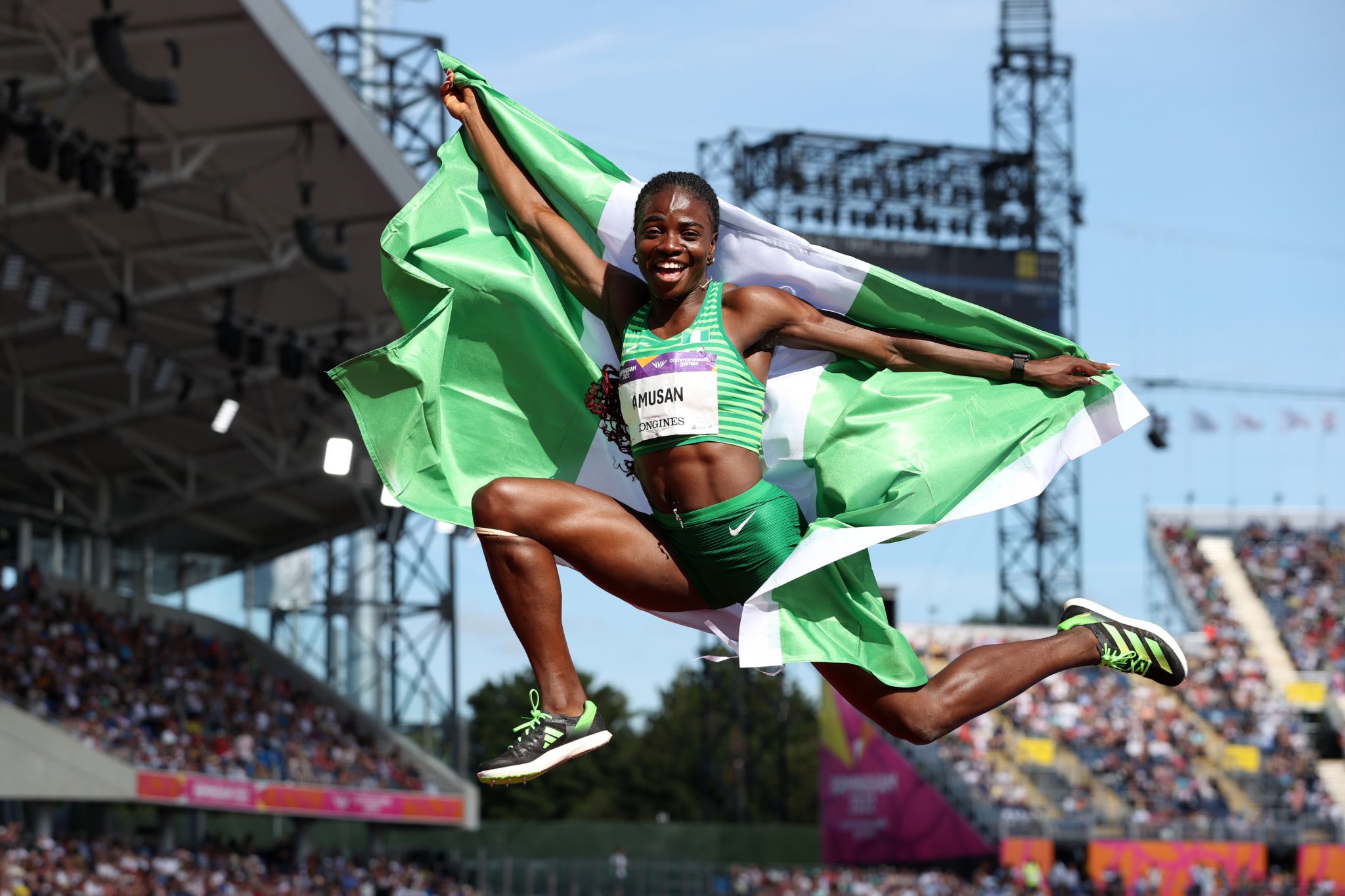 Nigerian sprinter and World 100 meter hurdles champion, Tobi Amusan in celebration withthe Nigerian flag. Photo Credit- Premium Times