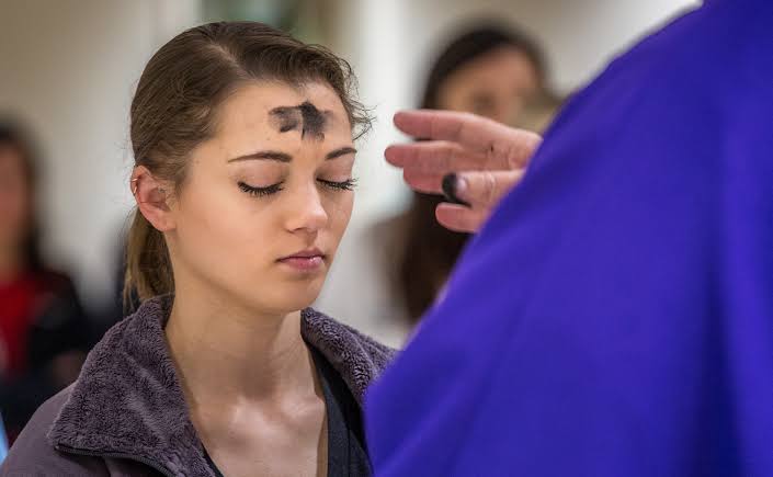 A Catholic lady receiving ash on Ash Wednesday