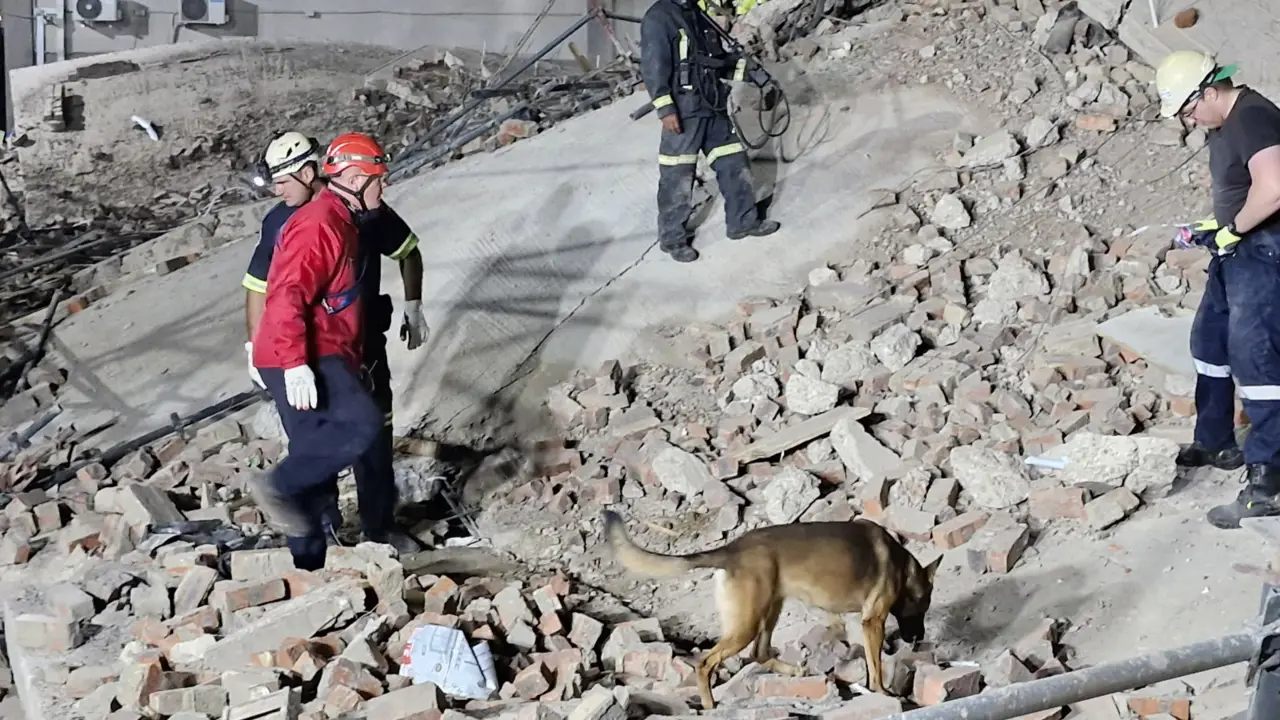 Rescue teams and sniffer dogs work at the scene of a building collapse in George, Western Cape, on 6 May 2024.