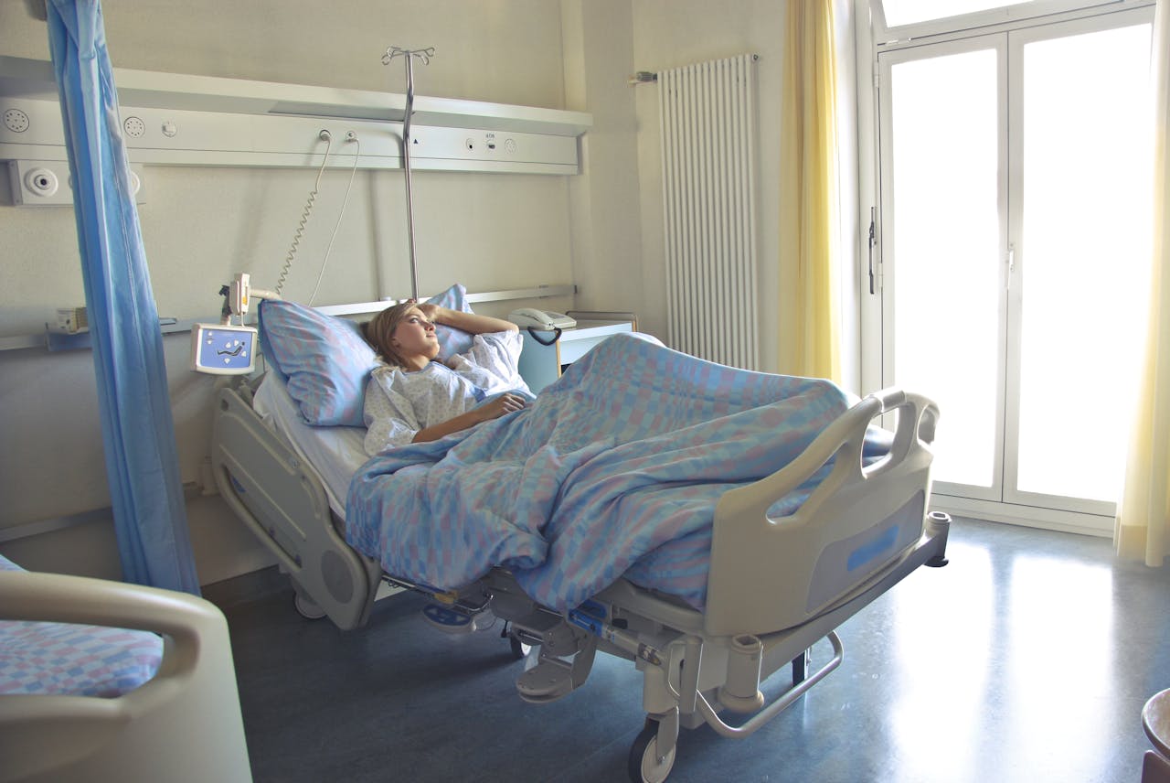 A patient lying down in a hospital room