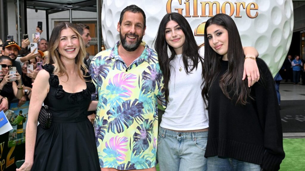 Adam Sandler beams with pride alongside his daughters, Sadie and Sunny, at the premiere of "Happy Gilmore 2"—a true family affair.