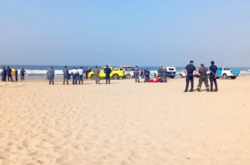 Rescue and emergency teams wait on shore as a helicopter and NSRI boats search the sea for the missing pilot.