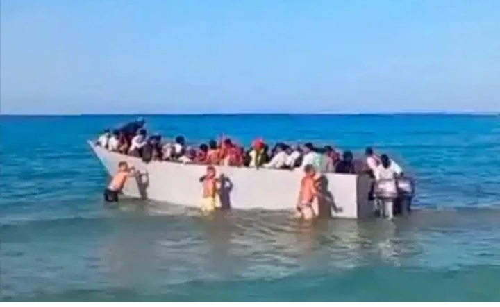  Greek island beachgoers push migrant boat back to sea amid rising arrivals from Libya