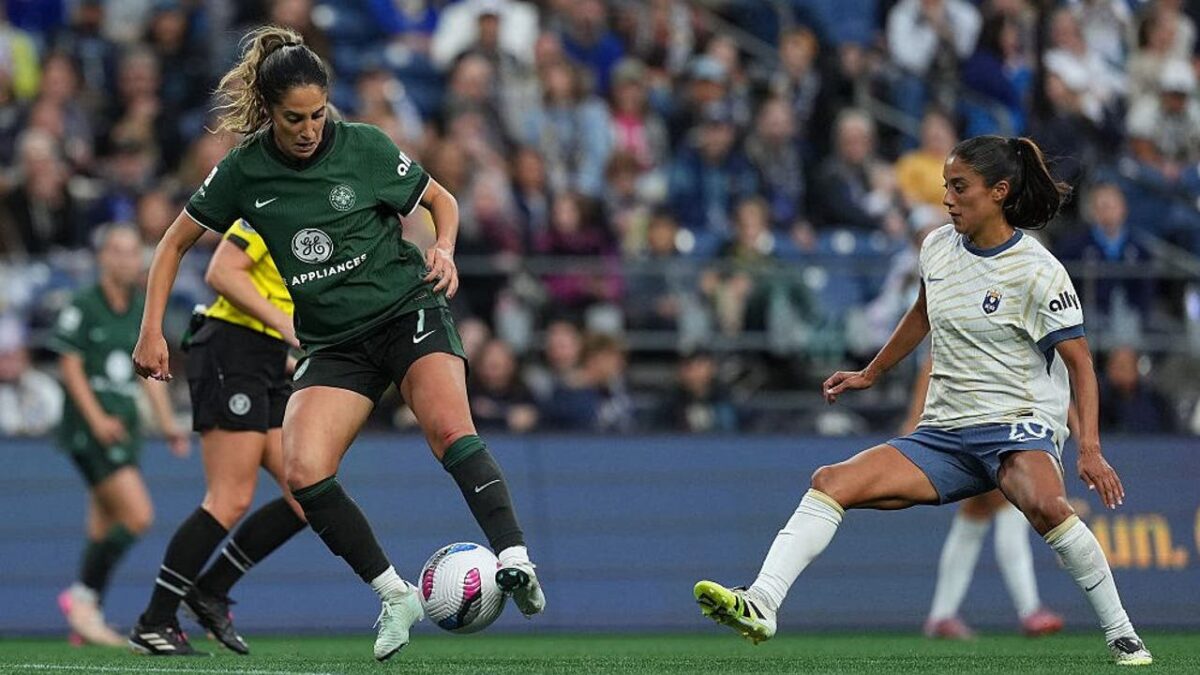Savannah DeMelo of Racing Louisville FC is put under pressure by Sam Meza of Seattle Reign FC during the NWSL match between Seattle Reign and Racing Louisville at Lumen Field on September 14, 2025 in Seattle. Image Credit: Soobum Im/NWSL/Getty Images