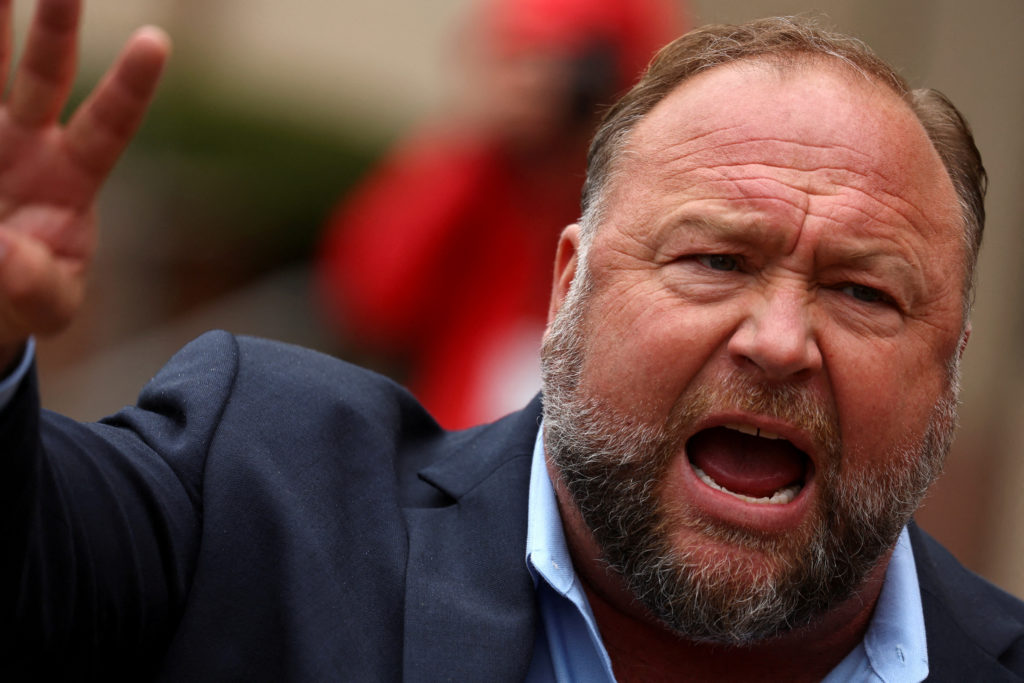 Infowars founder Alex Jones speaks to the media after appearing at his Sandy Hook defamation trial at Connecticut Superior Court in Waterbury, Connecticut, Oct. 4, 2022. Image Credit: Mike Segar/REUTERS
