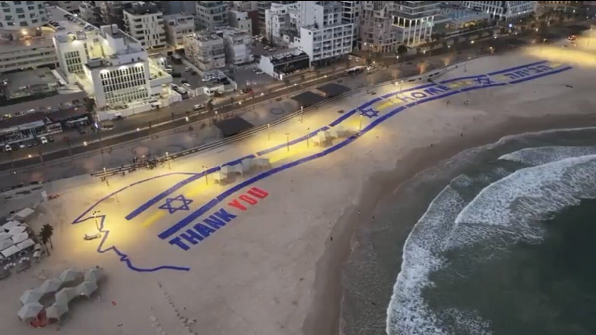 A sign thanking President Trump for hostages release seen from Air Force One as it flew over Tel Aviv upon arrival.