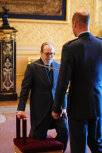 Sir Gary Oldman getting knighted by Prince William. Image Credit: Jonathan Brady/PA