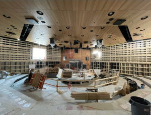 Inside the Elie Weisel Auditorium, wood panels are being installed in the Forum Building.