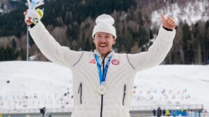 Ben Ogden, of the United States, poses after winning the silver medal in the cross-country skiing men's sprint classic at the 2026 Winter Olympics, in Tesero, Italy, Tuesday, Feb. 10, 2026. (AP Photo/Evgeniy Maloletka)