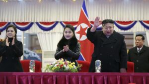 North Korean leader Kim Jong Un waves while his wife, Ri Sol Ju, left, and his daughter, Ju Ae, look on at a New Year’s Eve performance in Pyongyang. (Korean Central News Agency / Korea News Service)