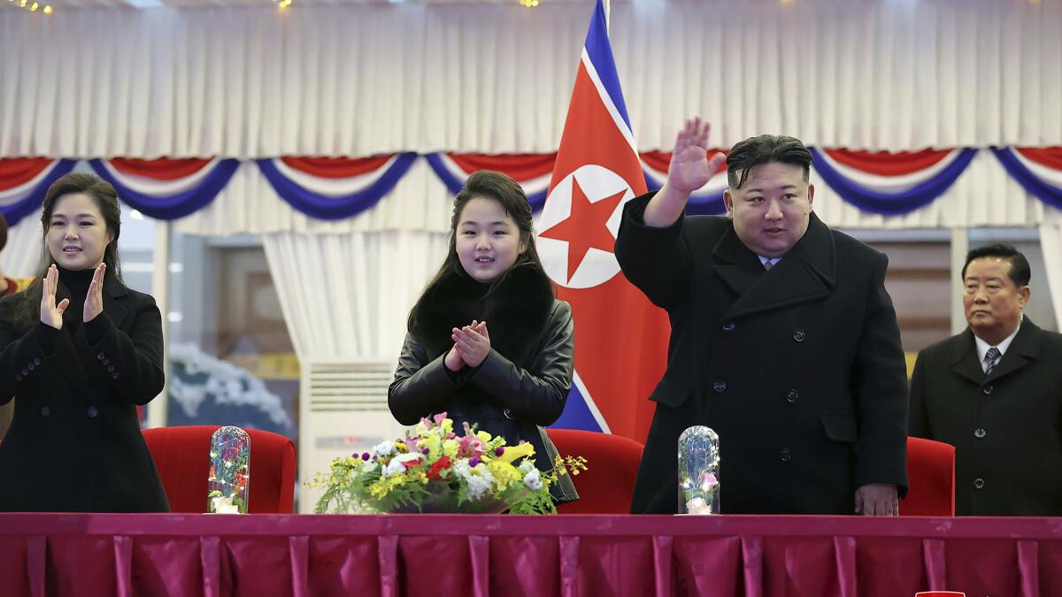 North Korean leader Kim Jong Un waves while his wife, Ri Sol Ju, left, and his daughter, Ju Ae, look on at a New Year’s Eve performance in Pyongyang. (Korean Central News Agency / Korea News Service)