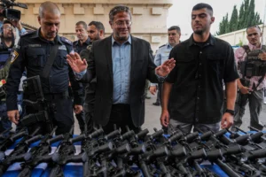 National Security Minister Itamar Ben-Gvir attends an event to deliver weapons to local volunteer security group members in Ashkelon, October 27, 2023. (AP/Tsafrir Abayov)