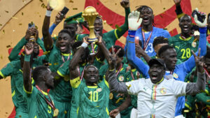 Senegal's Sadio Mane, surrounded by teammates, holds the AFCON trophy aloft after his team's 1-0 win over Morocco in the final in Rabat in January © SEBASTIEN BOZON / AFP/File