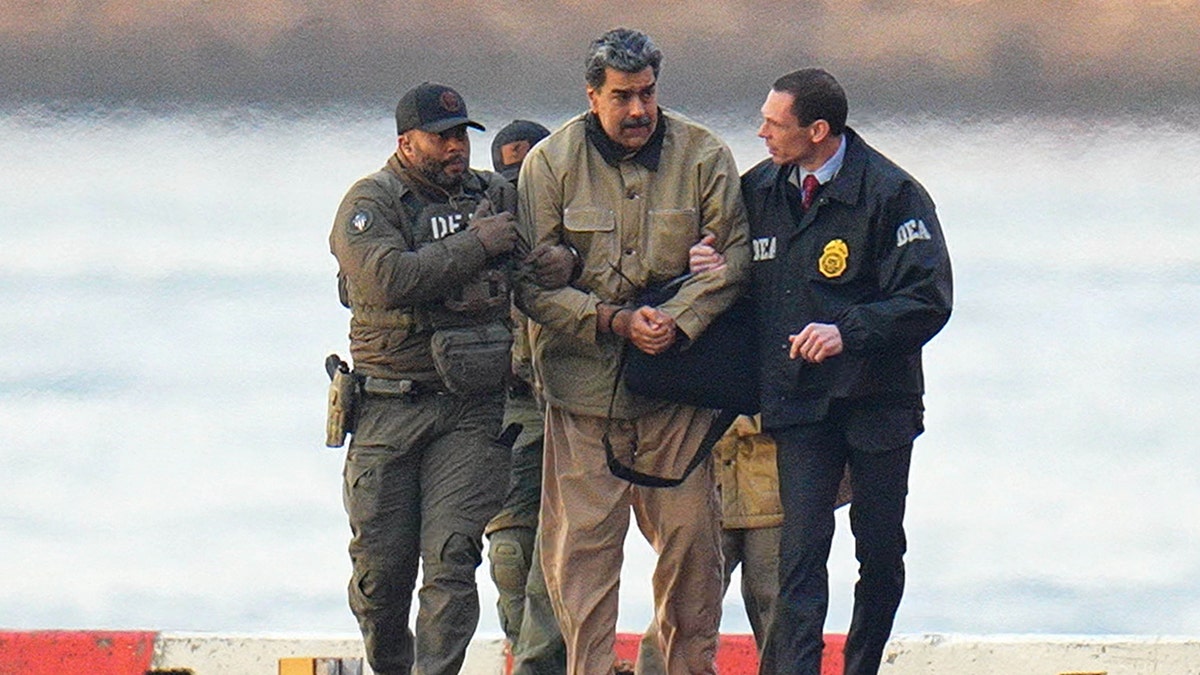 Nicolás Maduro is seen in handcuffs after landing at a Manhattan helipad, escorted by heavily armed federal agents as they make their way into an armored car en route to a federal courthouse in Manhattan on Jan. 5, 2026 in New York City. (XNY/Star Max/GC Images via Getty Images)