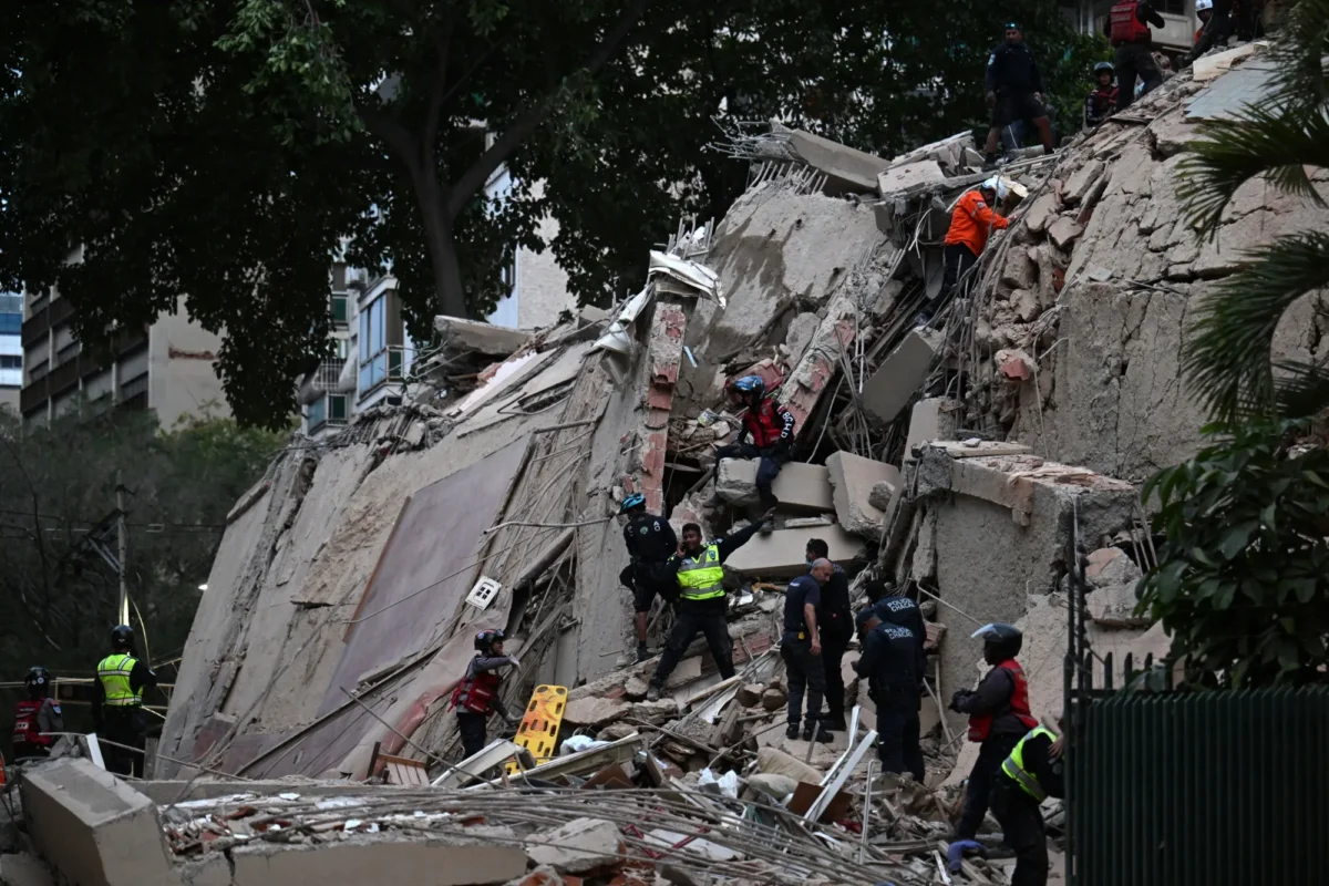 Rescuers search for victims in a collapsed building following an earthquake in Caracas, Venezuela on June 24. Photographer: Juan Barreto/AFP/Getty Images