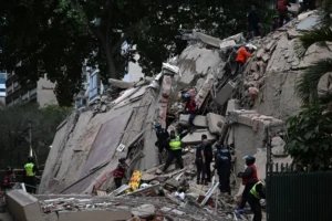 Rescuers search for victims in a collapsed building following an earthquake in Caracas, Venezuela on June 24. Photographer: Juan Barreto/AFP/Getty Images
