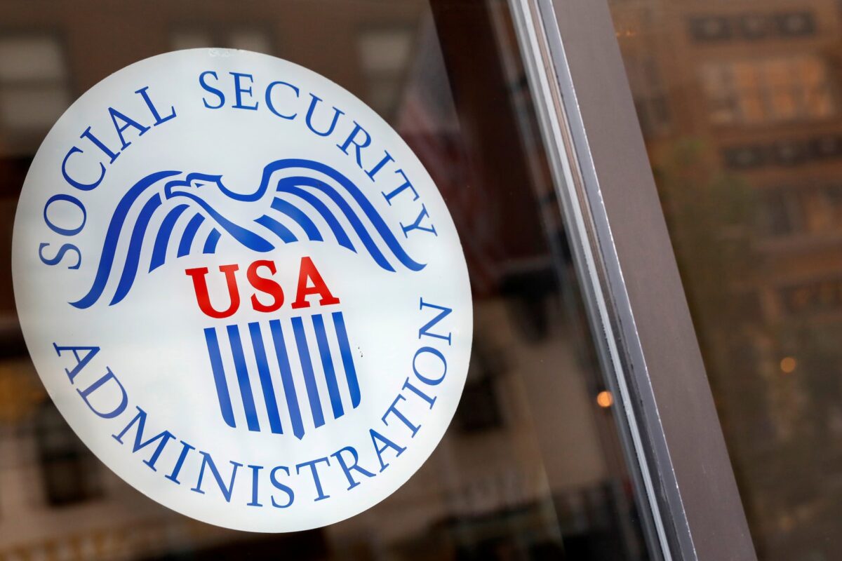 A sign is seen on the entrance to a Social Security office in New York City, U.S., July 16, 2018. REUTERS/Brendan McDermid/File Photo