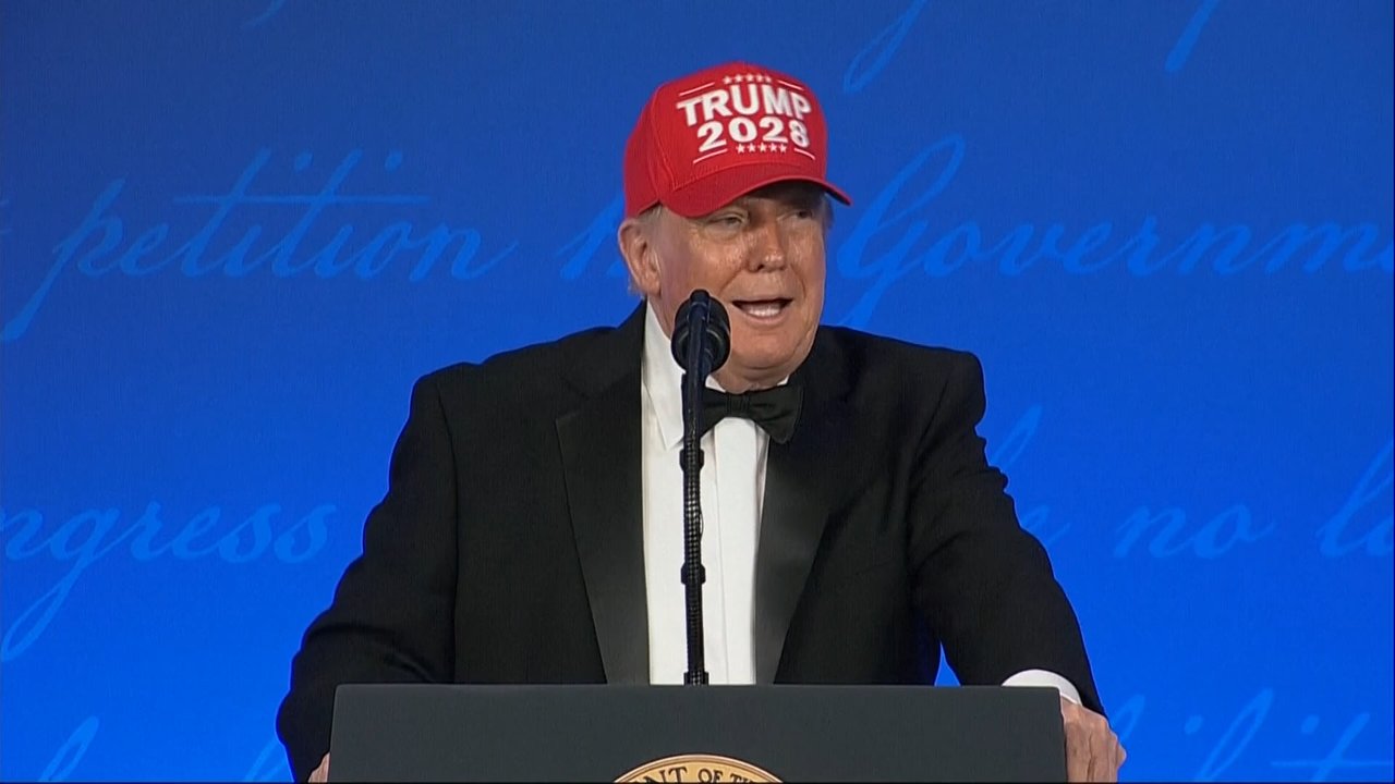 President Donald Trump wears a "Trump 2028" hat during the White House Correspondents' Dinner